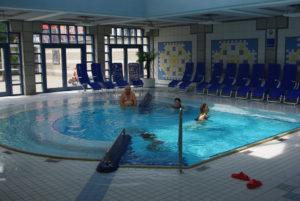 people enjoying in an indoor spool pool