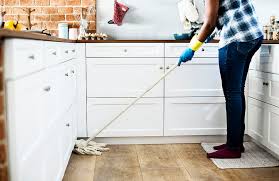 Lady Cleaning kitchen floor