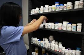 Girl organizing a medicine cabinet
