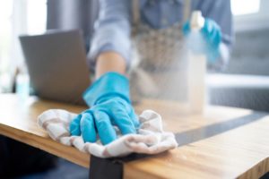 Woman cleaning a table for Allergen Reduction