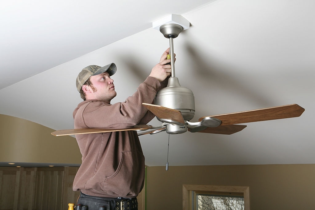 A Man installing a ceiling fan