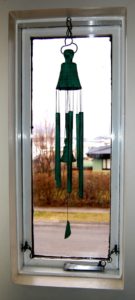 Feng shui wind chimes hanging on a window