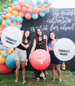 3 girls holding big balls on a graduation party