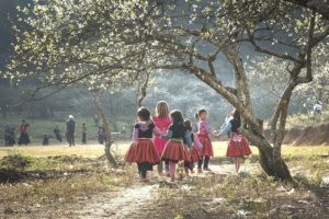 Girls playing under a tree